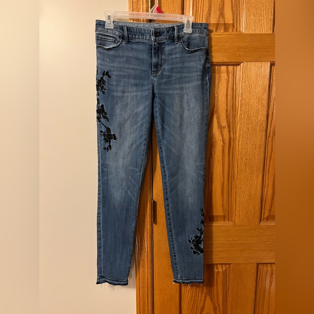 White House Black Market jeans with black floral embellishments, size 4